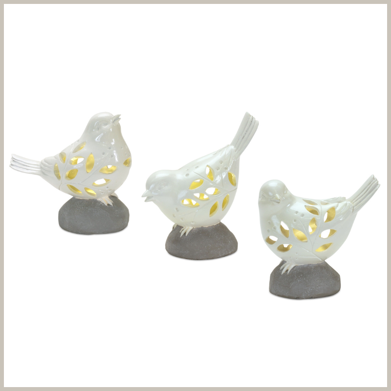 A set of 3 creamy white birds perched on stones, each with own pose. Cut out leaf designs on bodies to allow LED lights to glow through.