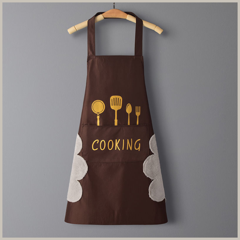 Kitchen apron. Brown with gold utensils across front. Side hand wiping patches on each side. Front pocket with the word cooking across it.