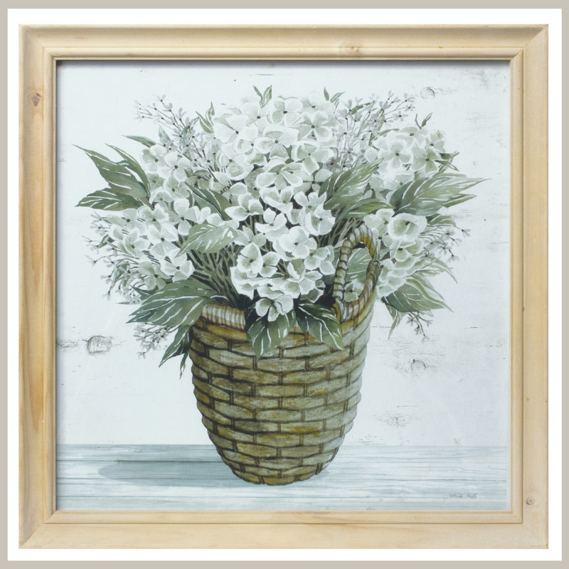 A framed print of pansies in a woven basket. Natural wood frame.