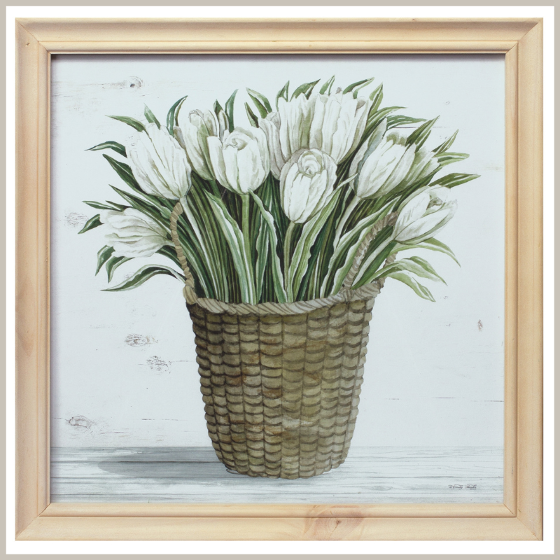 A framed print of tulips in a woven basket. Natural wood frame. 