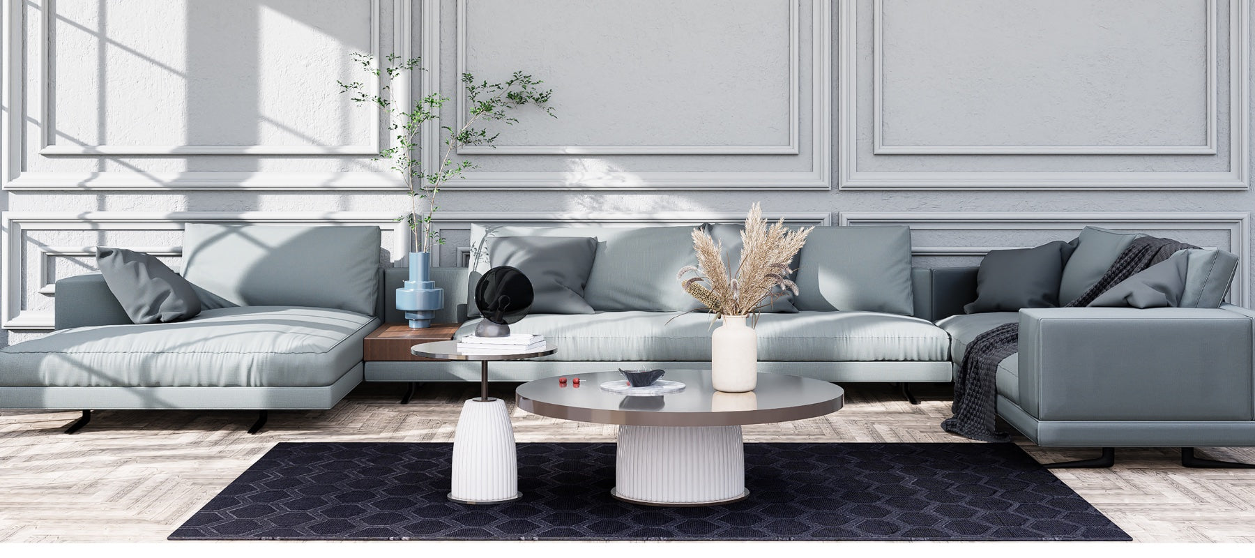 Gray couch with coffee table rug and vases with flowers
