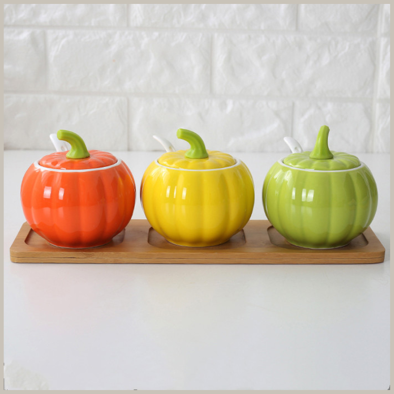 Ceramic Gourd Seasoning Jar Set sitting on a rectangular wood tray. 