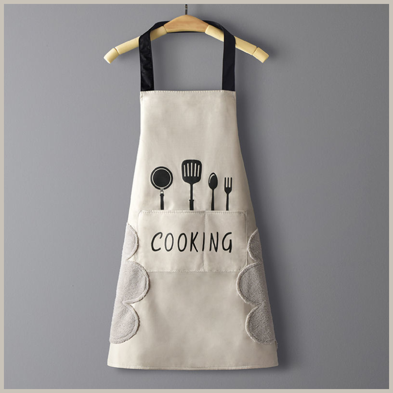 Kitchen apron. Tan with black utensils across front. Side hand wiping patches on each side. Front pocket with the word cooking across it.