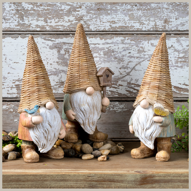 A set of three gnomes. Each wearing a faux wicker hat. Wood grain design bodies. Long white beards. Each one holds either a butterfly, birdhouse or bluebird. Delightful. 